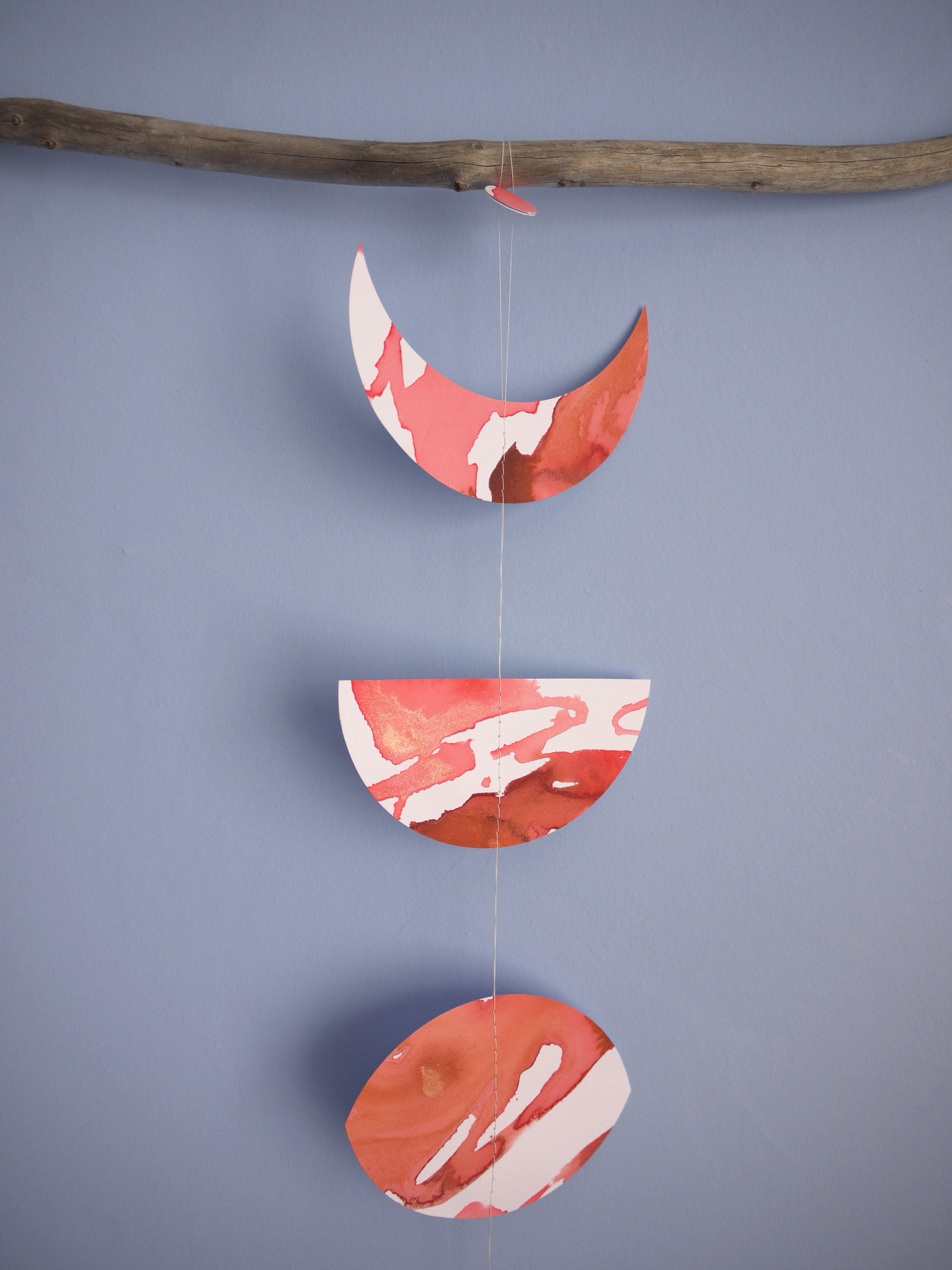 Red and white moon phase shapes on a blue background