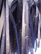 Close up on navy tassels with a silver constellation design