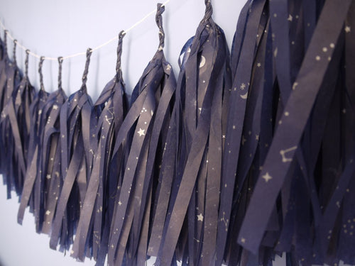 Close up on navy tassel garland with a silver constellation design