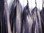 Close up on navy tassels with a silver constellation design