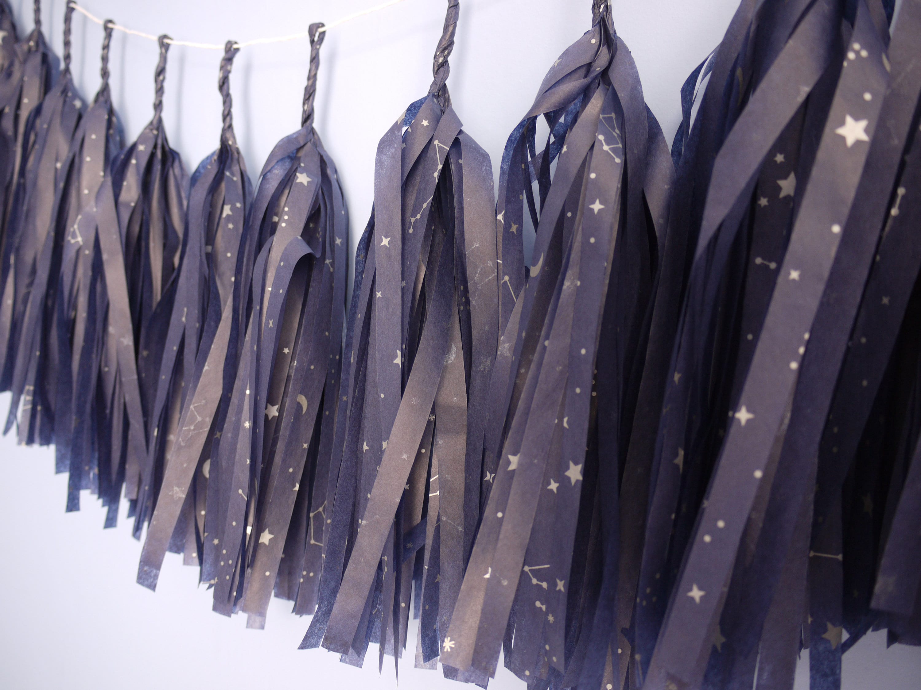 Close up on navy tassels with a silver constellation design