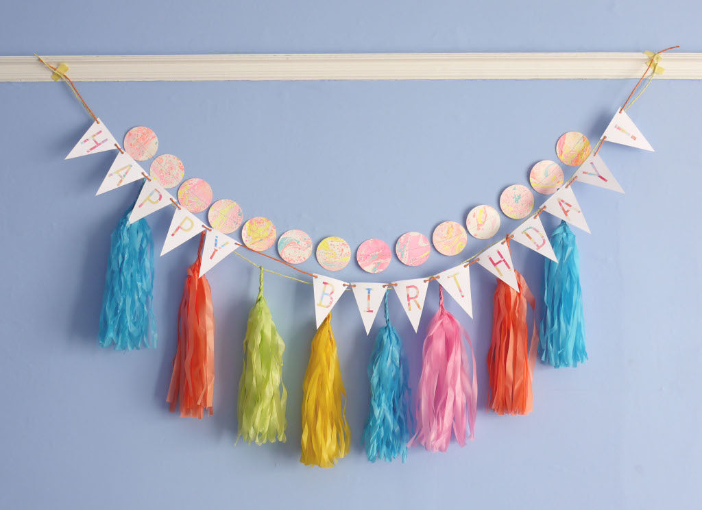 Colorful tassel banner with paper flags on a blue background