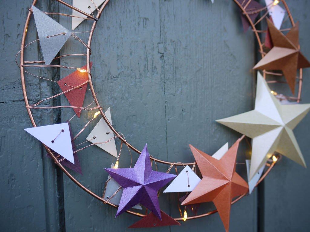 Decorative wreath with star-shaped ornaments on a dark surface