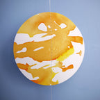Close up on full moon of a paper garland. Hand-painted with yellow, orange and gold ink this decorative yelllow paper garland creates a full moon phases wall hanging