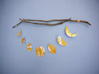Flower Moon phases wall hanging for May birthday gift. Hand-painted with yellow, orange and gold ink this decorative paper garland creates a full moon phases wall hanging. Hung here horizontally from driftwood