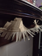 Close up on gold paper streamer at a mantelpiece