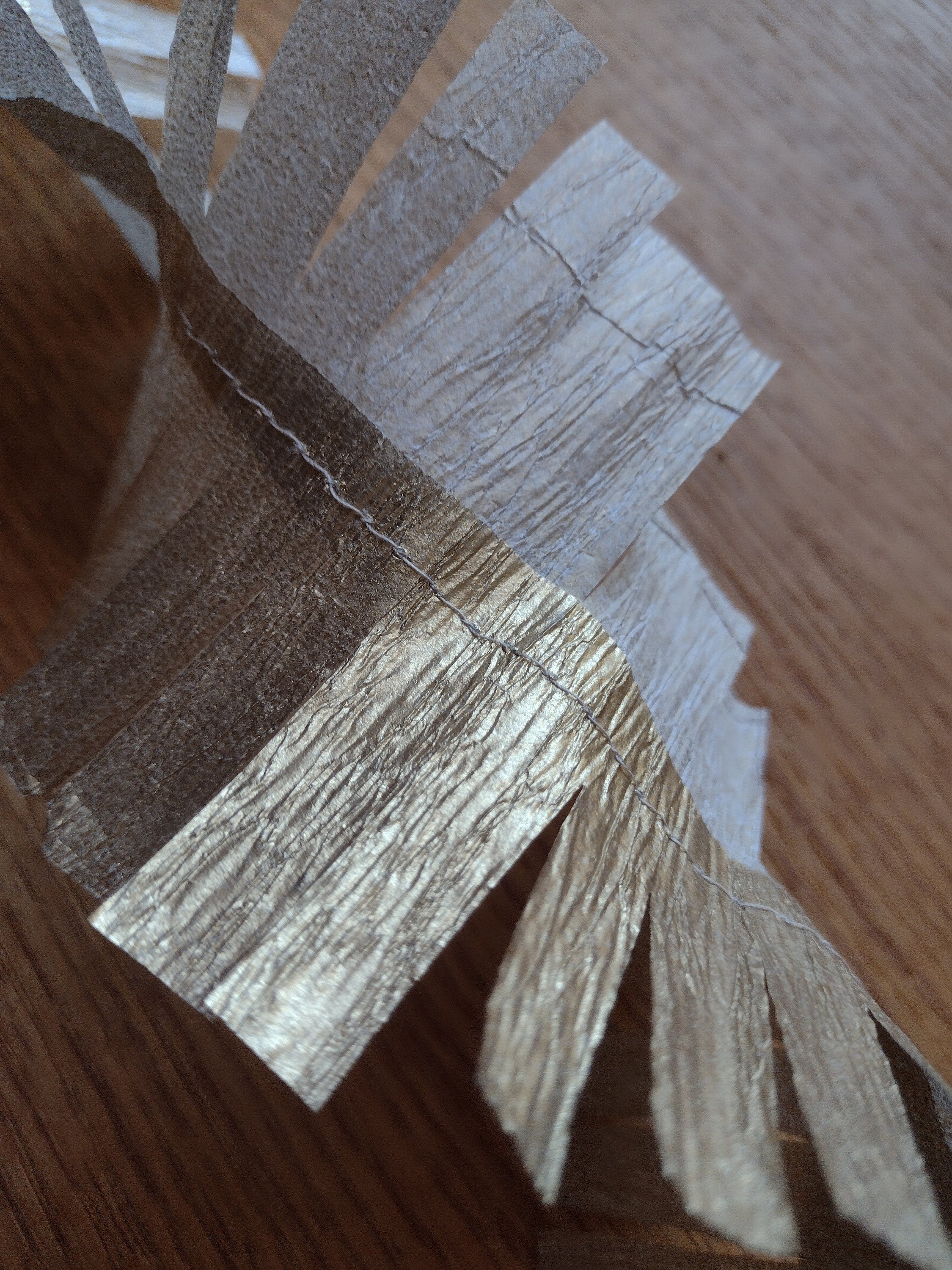 Close up on gold paper streamer on a wooden surface