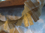 Close up on gold paper decorations at a mantelpiece