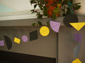 Bold colourful multi shape paper garland with yellow, black and lavender