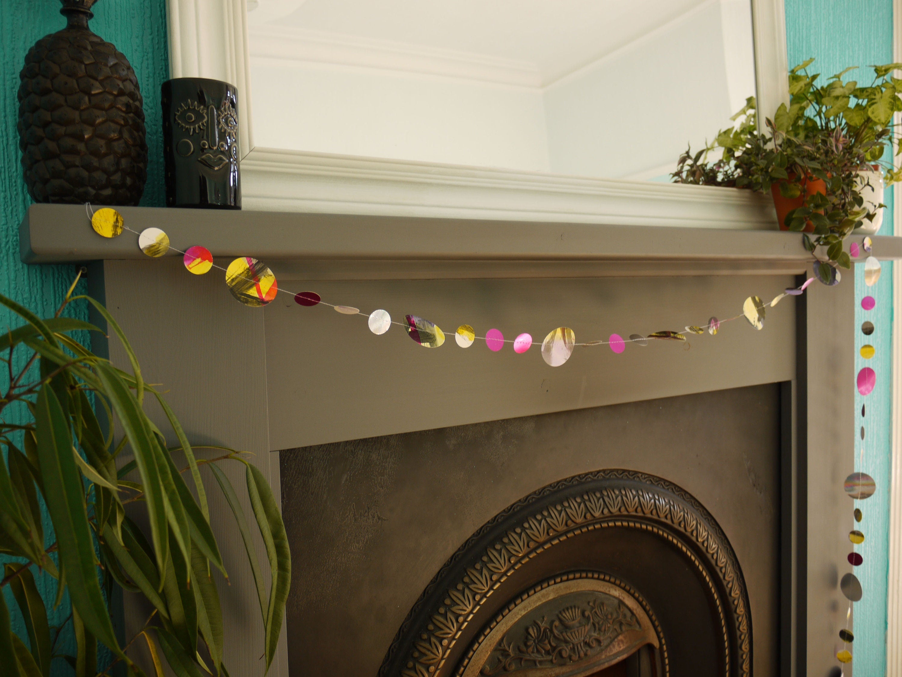 Painted paper garland in bold colours of pink, yellow, black, purple and holographic