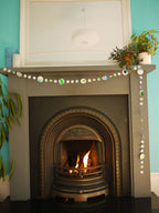 Handpainted watercolour paper garland at a fireplace