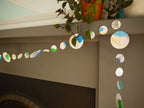 Handpainted watercolour paper garland at a fireplace
