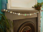 Handpainted watercolour paper garland at a fireplace