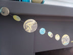 Close up on yellow, blue and grey marbled paper circle garland