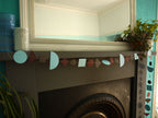Modern multi shape paper garland in Paper Street Doll's RAGNAR colours of sky blue, charcoal and rust