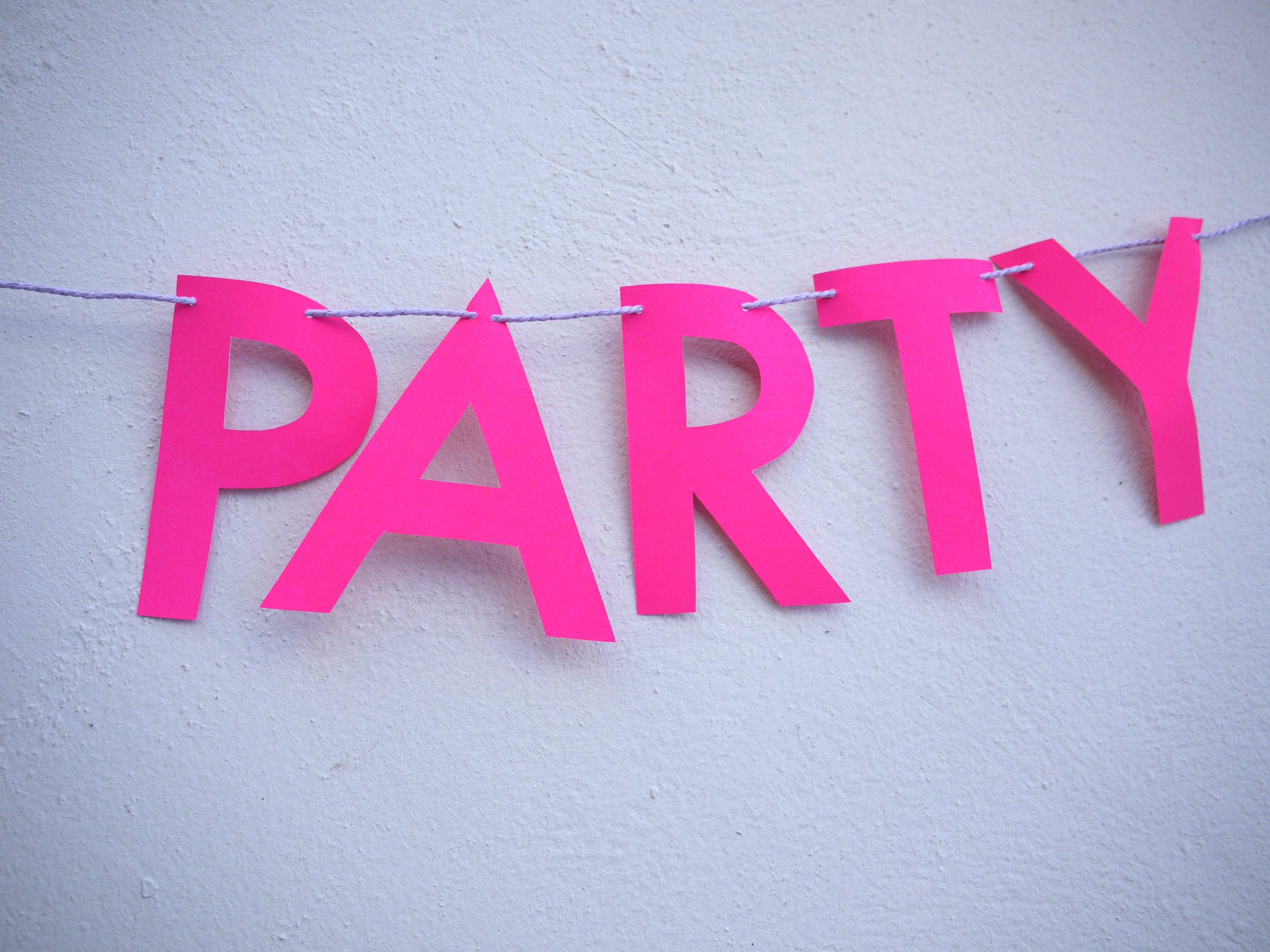 Pink 'PARTY' banner on a white background