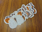 Butterfly garland on a wooden surface. Riso print shapes sewn for naturalist home decor.