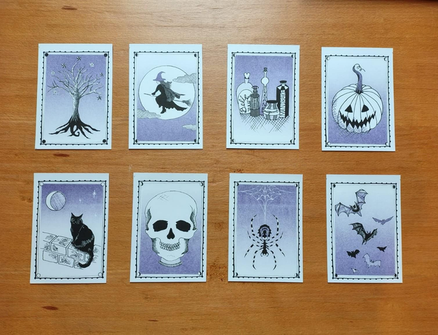 Set of Halloween-themed riso prints on a wooden surface