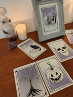 Tarot style Halloween theme riso prints with black, white and purple illustrations - pumpkin, black cate, skull, tree and potions