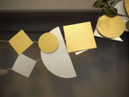 Metallic geometric sewn paper garlands with gold and silver shapes including circles, squares, and triangles. Fun easy party themes to take away the stress of decorating.