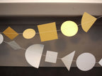 Metallic geometric shape garlands in gold and silver. Fun easy party themes to take away the stress of decorating