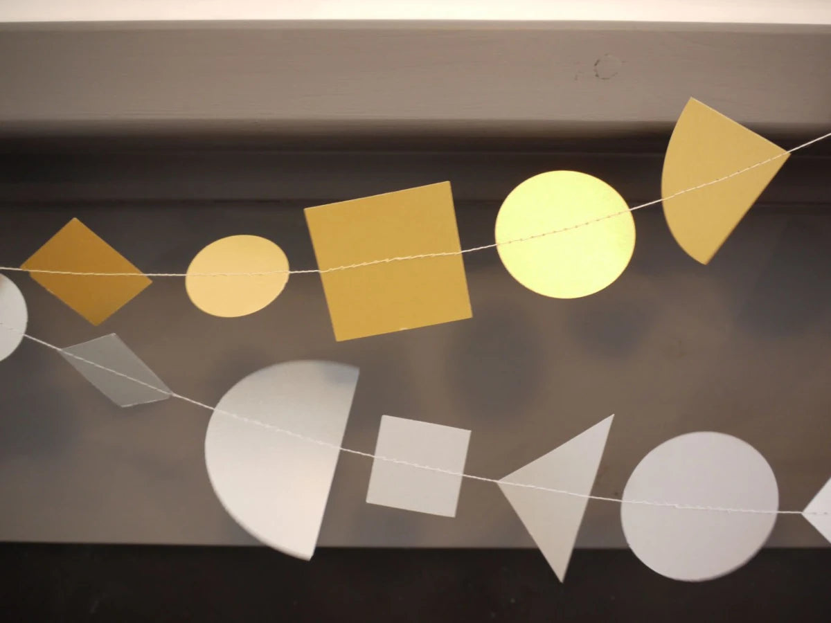 Metallic geometric shape garlands in gold and silver. Fun easy party themes to take away the stress of decorating
