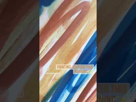 A close up view on painted paper that becomes Jupiter in Paper Street Dolls abstract Solar System wall hanging