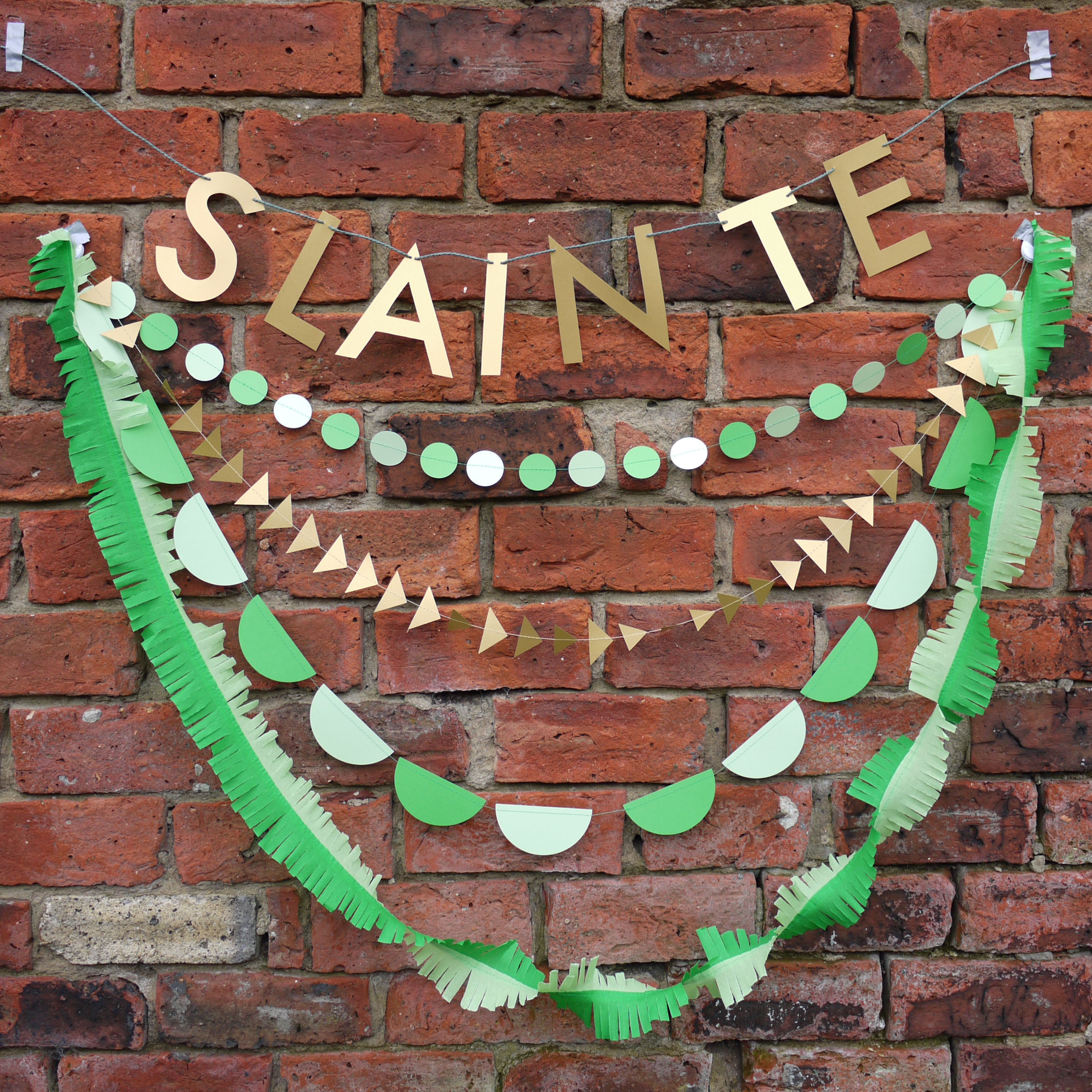 Decorative banner with 'SLÁINTE' on a brick wall