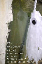 A spooky but cute Halloween white ghost tassel decoration with a black eye on a weathered green door, with the title text 'DR. MALCOLM CROWE A PSYCHIATRIST BY TRADE, *SPOILER ALERT* HE SEES LIVING PEOPLE' in white font.